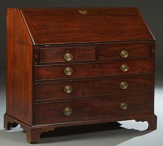 English Inlaid Carved Mahogany Georgian Style Slant Front Desk, 19th c., the slant lid opening to a gilt tooled brown leather writing surface, and an 