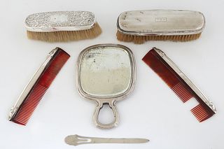 Six Sterling Pieces, consisting of a man's four piece dresser set, c. 1930, with three brushes and a hand mirror, with line decoration; together with 