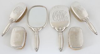 Sterling Six Piece Dresser Set, early 20th c., consisting of two combs, two hair brushes, and two beveled hand mirrors, Brushes- H.- 9 in., W.- 9 1/4 