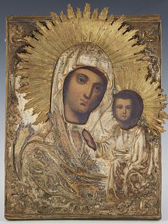 Russian Icon of Madonna and Child, 19th c., with a brass repousse oklad, on a curved wood panel, H.- 9 1/4 in., W.- 6 3/4 in.