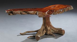 In the Manner of George Nakashima, Walnut Slab Coffee Table, 20th c., on a central driftwood base, H.- 18 3/8 in., W,- 46 1/2 in., D.- 19 in.