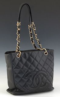 Chanel Petit Shopping Tote, in black caviar quilted calf leather with gold hardware, opening to a black leather lined interior with one zip closure si