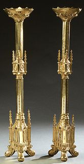 Pair of Gothic Style Gilt Brass Altar Candlesticks, 20th c., the sloping top with cross cutouts, on a hexagonal support, to a center knop with Gothic 