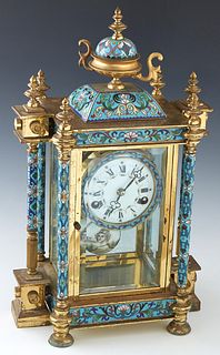 Cloisonne Mantel Clock, 20th c., with an urn surmount over a square cloisonne plinth, above a painted enamel dial, of a time and strike clock, flanked