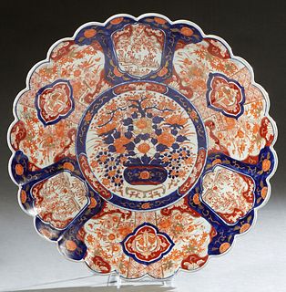 Large Japanese Imari Porcelain Circular Charger, 20th c., the scalloped edge around medallion reserves of flowers and birds, around a central circular