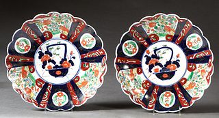 Pair Large Japanese Imari Circular Porcelain Chargers, 20th c., the scalloped edge around medallion reserves of flowers and birds, around a central ci