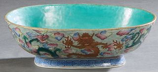 Chinese Oval Porcelain Footed Serving Bowl, 19th c., aqua glazed interior within an exterior with elaborate dragon decorations, on a blue Greek key de