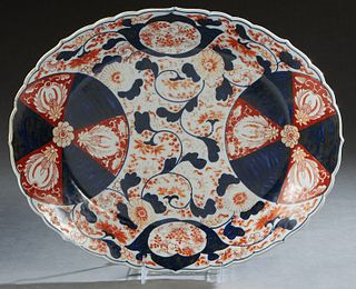Japanese Imari Oval Porcelain Platter, 20th c., the scalloped edge around medallion reserves of flowers, around a central reserve of flowers and leave