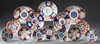 Fourteen Pieces of Imari, 20th c., consisting of four matching shallow circular plates, six circular bowls, a scalloped plate, a scalloped charger, an
