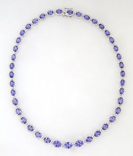 14K White Gold Link Necklace, each of the forty-one oval links with a graduated oval tanzanite atop a border of tiny round white diamonds, total tanza