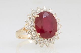 Lady's 14K Yellow Gold Dinner Ring, with an oval 8.52 carat ruby, atop a double graduated concentric border of round diamonds, on a split shoulder ban