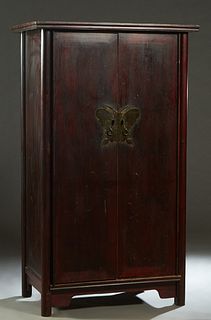 Chinese Carved Elm Noodle Cabinet , c. 1880, the ogee crown over double doors with a brass metal butterfly lock, on a bracketed plinth on cylindrical 