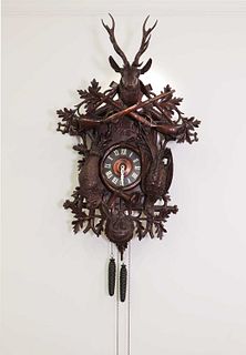 A large carved Black Forest wall-hanging cuckoo clock,