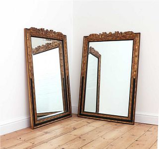 A pair of ebonised and parcel-gilt mirrors,