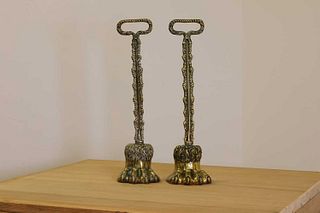 A pair of cast brass door porters,