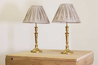 A pair of gilt-bronze candlestick lamps