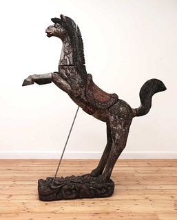 A South-East Asian carved and polychrome painted wooden horse,