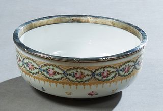 Sevres Style Sterling Rimmed Bowl, 20th c., with a gilt and floral decorated border above gilt leaf and floral decoration, the under side with a spuri