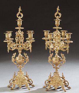 Pair of Italian Brass Five Light Candelabra, 20th c., with a central relief decorated candle cup atop a knopped support issuing four scrolled candle a