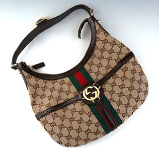 Gucci Reins Hobo PM Bag, in beige monogram canvas with brown leather accents and golden hardware, opening to a dark brown canvas lined interior with a