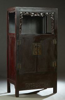 Chinese Carved Elm Worship or Display Cabinet, 19th c., the rectangular top over open storage behind a pierced border, above double doors with brass h