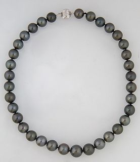 Graduated Strand of Thirty-Five Dark Grey Tahitian Cultured Pearls, ranging from 11-13mm, with a 14K white gold ball clasp, L.- 17 1/2 in., with appra
