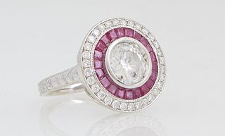Lady's 18K White Gold Dinner Ring, with a central 1.53 carat round diamond atop a border of trapezoidal rubies, within a border of small round diamond