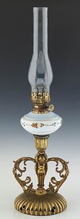 Brass and Enameled Glass Oil Table Lamp, late 19th c., with a brass regulator over an enameled glass font, on a figural putti support, to a reeded slo