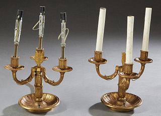 Pair of Brass Three Light Candelabra Lamps, 20th c., the three relief leaf form arched arms emanating forma reeded support, topped by fletching, on a 