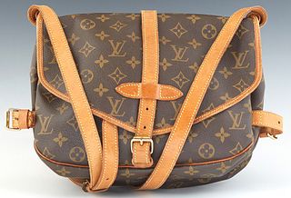 Louis Vuitton Saumur 25 Shoulder Bag, in brown monogram coated canvas with vachetta leather strap and golden brass hardware, opening to a brown canvas