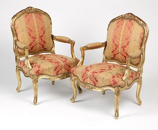 A pair of French giltwood fauteuils
