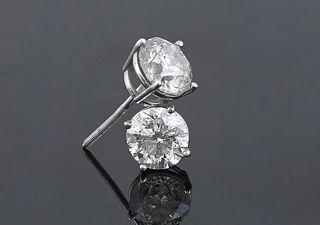Pair of 18K White Gold Diamond Stud earrings, each with a prong set round diamond, one- .93 cts., the other- .95 cts., total diamond wt.- .1.88 cts., 