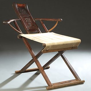 Chinese Ming Style Carved Elm Folding Armchair, 19th c., with a bowed vertical splat over a canvas seat, H.- 38 in., W.- 38 1/2 in., D.- 48 in.