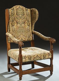 English Carved Oak Wing Chair, late 19th c., the arched back over two wings and upholstered curved arms, above an upholstered seat, on turned and squa