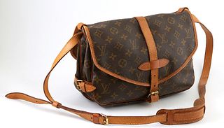 Louis Vuitton Saumur Coated Monogram Canvas 25 Shoulder Bag, with golden brass hardware, each side opening to a brown canvas interior, the adjustable 