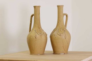 A pair of pottery ewers,