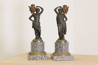 A pair of bronze figural candlesticks,