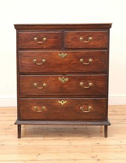 A narrow oak chest of drawers,