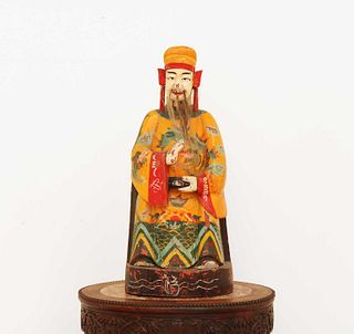 A Chinese polychrome painted wooden house god or attendant,