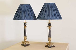 A pair of French Empire-style patinated and gilt-bronze candlestick lamps