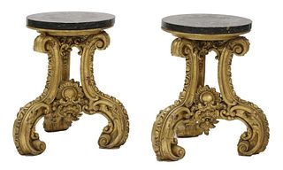 A pair of ornately carved giltwood stands,