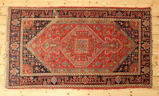 A Persian wool rug,