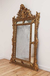 A large Dutch-style gilt-framed wall mirror,