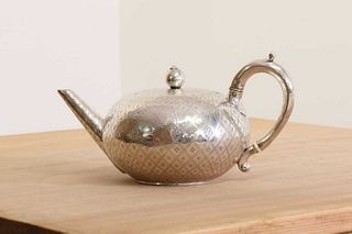 A Victorian silver teapot with ivory insulators,