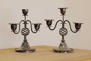 A pair of silver-plated candlesticks,