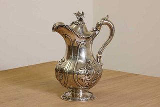A Victorian silver hot water jug with ivory insulators,