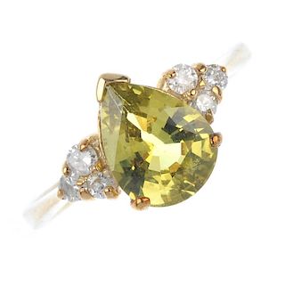 A 9ct gold chrysoberyl and diamond ring. The pear-shape chrysoberyl, with brilliant-cut diamond tref