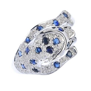 A 9ct gold sapphire and diamond leopard ring. The pave set circular-shape sapphire leopard, with sin