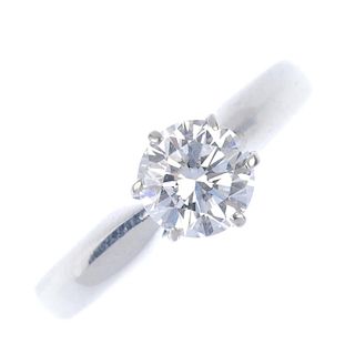 A platinum diamond single-stone ring. The brilliant-cut diamond, weighing 0.68ct, to the tapered sho