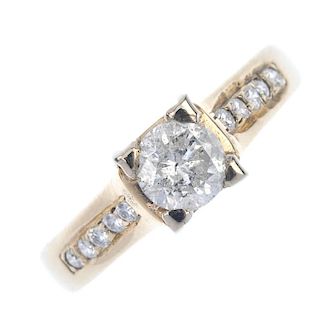 An 18ct gold diamond single-stone ring. The brilliant-cut diamond, to similarly-cut diamond line sho